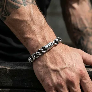 Close-up of polished titanium steel men's Cuban link bracelet with push button clasp