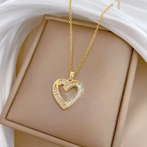 Detailed view of heart pendant featuring baguette-cut cubic zirconia in 18K gold finish