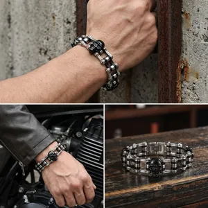 Detailed view of men's stainless steel bicycle chain bracelet with black skull accent