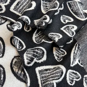 Close-up of heart pattern scarf showing soft cashmere-like texture and edge stitching