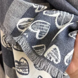 Close-up of cashmere-feel heart pattern scarf with fine tassel edge and woven texture