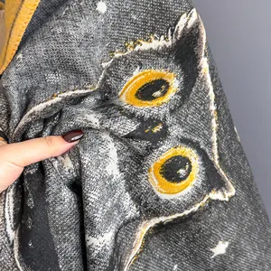 Detail shot of owl printed scarf fabric showing soft cashmere texture and fine knit quality