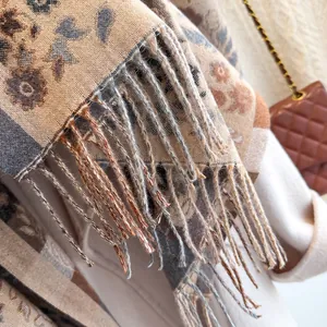 Close-up of winter scarf fringe detail with retro floral patterns and cashmere feel
