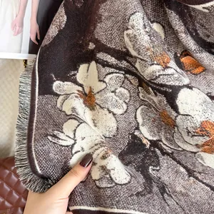 Close-up of soft floral jacquard shawl with plum blossom prints and tassel details