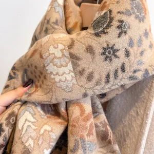 Close-up of thick cashmere-like scarf showing vintage floral patterns and soft texture