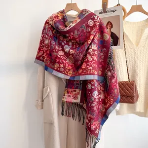 Close-up of vintage paisley pattern and soft tassels on thick red cashmere-like scarf