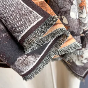 Macro detail of retro oil painting floral print scarf with fine fringe edge finish