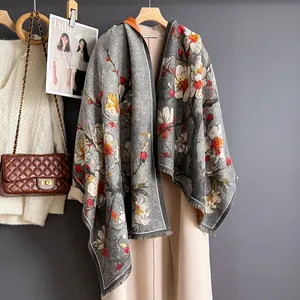 Detail of grey ethnic floral scarf with plum blossoms and delicate fringe edges