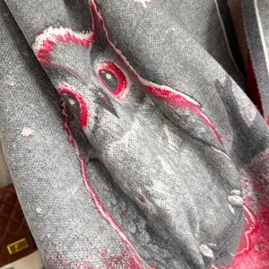 Detailed macro view of oil painting owl pattern on soft grey cashmere-like scarf