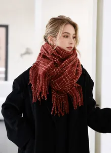 Close-up of classic burgundy plaid scarf with tassels and thick knitted texture detail