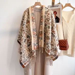 Detailed shot of ethnic paisley pattern and fringe tassels on a warm cashmere shawl