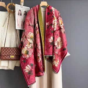 Red floral cashmere-feel scarf with plum blossom print over a long beige coat