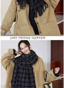 Close-up of black plaid scarf with fringe paired with a khaki jacket for winter style