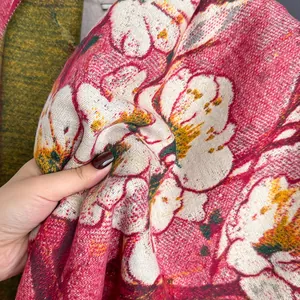 Detail of soft cashmere-like scarf showing vibrant floral patterns and fuzzy texture
