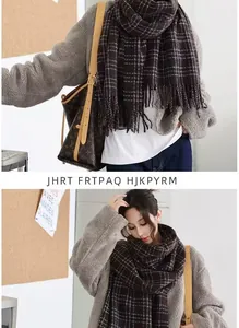 Detail of classic plaid pattern and soft tassels on a warm cashmere-feel winter scarf