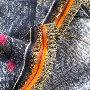 Close-up of thick oil painting style floral scarf with refined fringe edges and soft texture