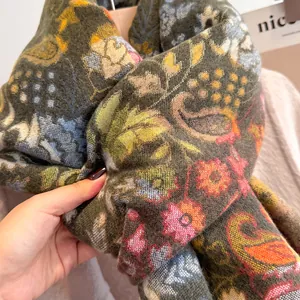 Close-up of thick cashmere-like scarf showing soft texture and vintage paisley patterns