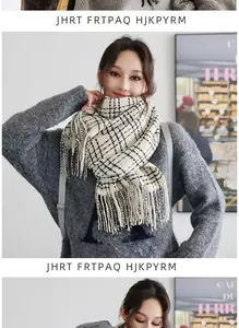 Detailed view of the classic black and white plaid scarf with soft tassel edges