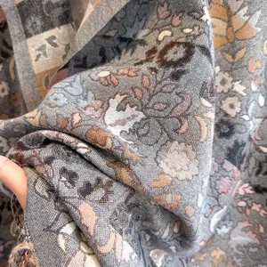 Macro view of woven paisley pattern with fringed edges on a soft warm cashmere-like scarf