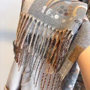 Detail shot of boho paisley scarf with fringe edges and premium cashmere feel fabric