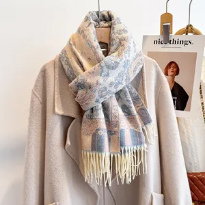 Detail of floral paisley jacquard scarf with soft beige fringe on a stylish beige coat