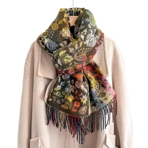 Colorful paisley cashmere-feel scarf with tassels draped over a beige winter wool coat