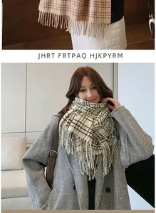 Detail showing classic check pattern texture and long tassels on warm autumn scarf