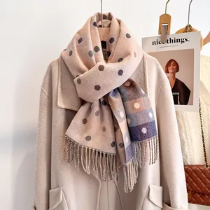 Close-up of soft beige scarf with colorful polka dots and fine fringe details
