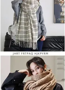 Detail of classic plaid pattern and fine fringe texture on soft beige winter scarves