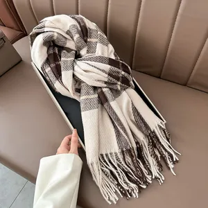 Close-up of thick plaid scarf featuring coffee and beige patterns with soft fringe details