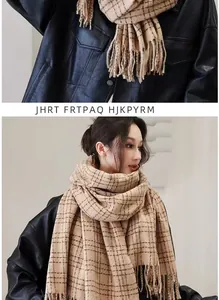 Detail of beige plaid scarf featuring soft cashmere-like texture and fringed edges
