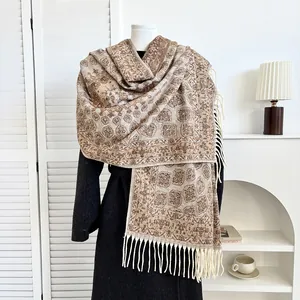 Detailed view of ethnic pattern print and long tassels on cashmere-like winter shawl scarf