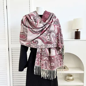Close-up of paisley pattern scarf with fringes draped over a black winter coat