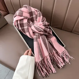 Close-up of pink and brown plaid scarf featuring soft cashmere-like texture and tassel trim