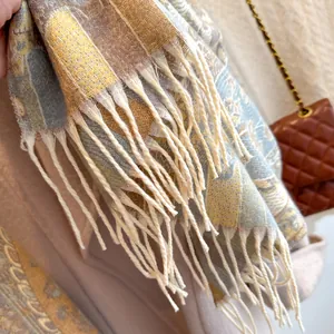 Macro detail of retro jacquard scarf showing soft texture and beige fringe tassels