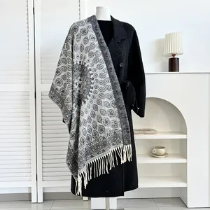 Ethnic bohemian paisley cashmere shawl with fringes on black wool coat for winter