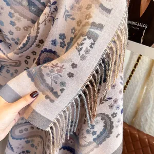 Close-up of soft paisley cashmere shawl showing fringe details and intricate patterns