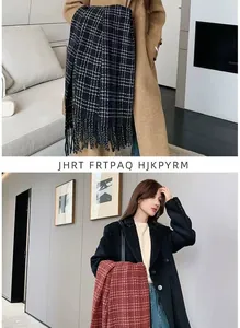 Detailed view of classic plaid scarf with soft fringe tassels in black and red patterns