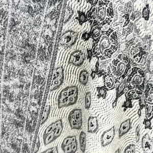 Close-up of ethnic style winter scarf showing thick cashmere texture and woven patterns
