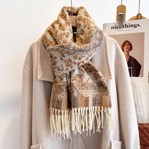 Ethnic floral thick scarf with fringe tassels draped over a beige winter coat
