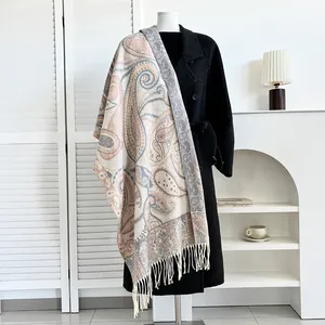 Ethnic paisley cashmere feel pashmina shawl with tassel fringe draped on a coat