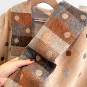 Macro shot showing the soft cashmere-like fabric texture and colorful polka dot pattern