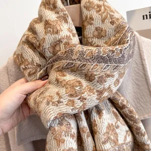 Detailed view of the soft vintage floral jacquard texture on this thick winter knit scarf