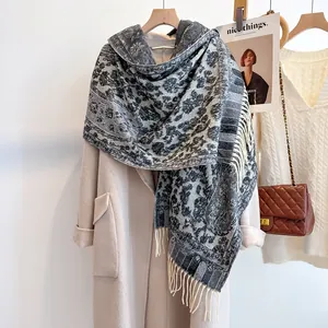Detail of vintage floral knit scarf with elegant fringe trim on heavy cashmere-like fabric