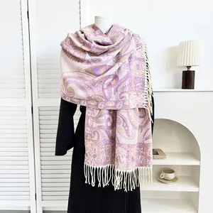 Detail of purple paisley pashmina shawl with soft fringe on a mannequin coat