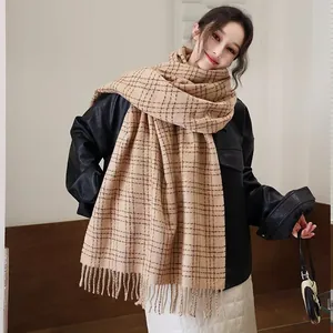 Classic khaki plaid scarf with fringe tassels paired with a stylish black leather jacket