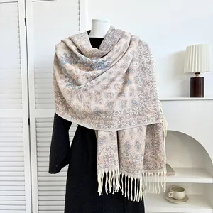 Detail of bohemian paisley pashmina shawl with thick fringe on a white mannequin