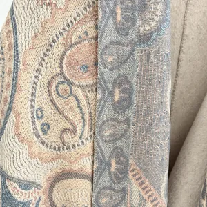 Close-up of ethnic paisley pattern on thick faux cashmere scarf with premium stitching detail