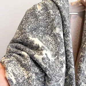 Close-up of double-sided cashmere-like shawl with artistic mountain and forest prints