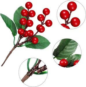 Detailed view of artificial red berries with realistic green leaves and stem texture